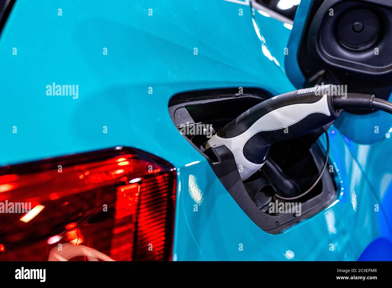 power supply for electric car charging, electric car charging station, close up of the power supply plugged into an electric car being charged Stock Photo