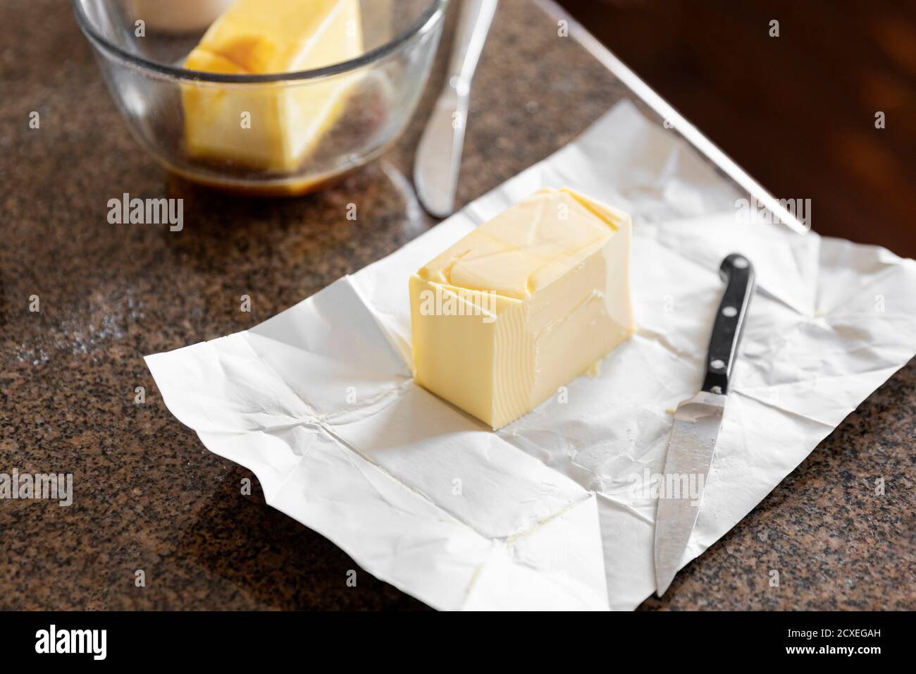 Sliced block of butter halved into a mixing bowl Stock Photo Alamy