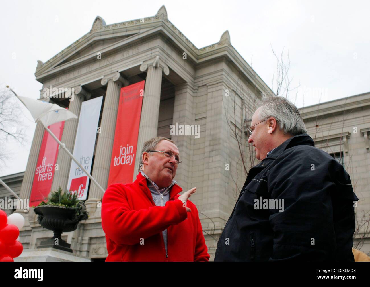 Museum of Fine Arts, Boston Director Malcolm Rogers (L) greets Steven Troxel, who travelled from Alexandria, Virginia and was the first person in line for the public opening of the museum's new Art of the Americas wing, in Boston, Massachusetts November 20, 2010. REUTERS/Brian Snyder (UNITED STATES - Tags: SOCIETY) Stock Photo