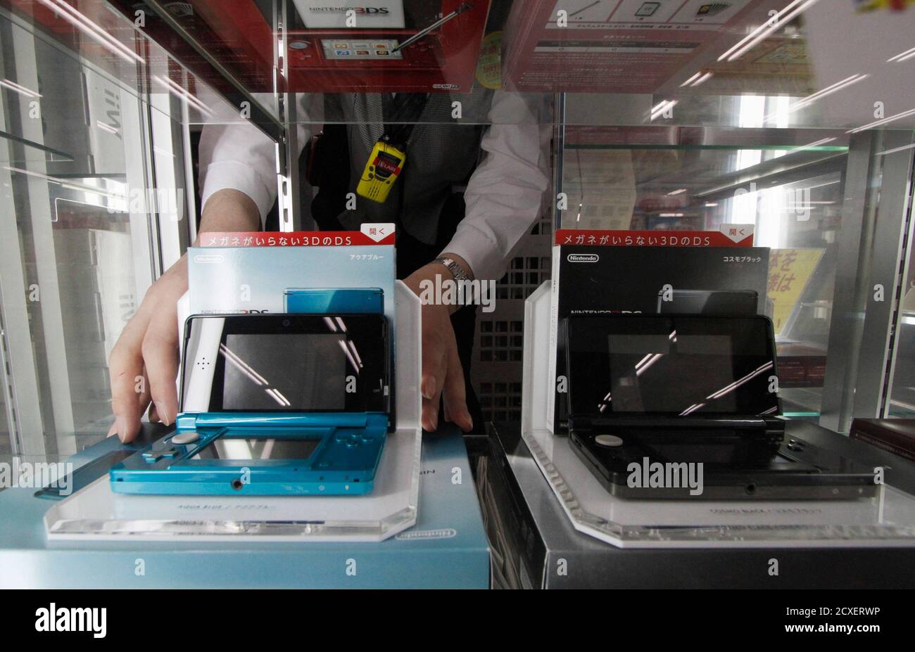 An Employee Arranges Nintendo 3ds Portable Game Consoles At A Yamada Denki Electronics Retail Store In Tokyo January 26 12 Nintendo Co Ltd Posted A 61 Percent Drop In Quarterly Operating Profit