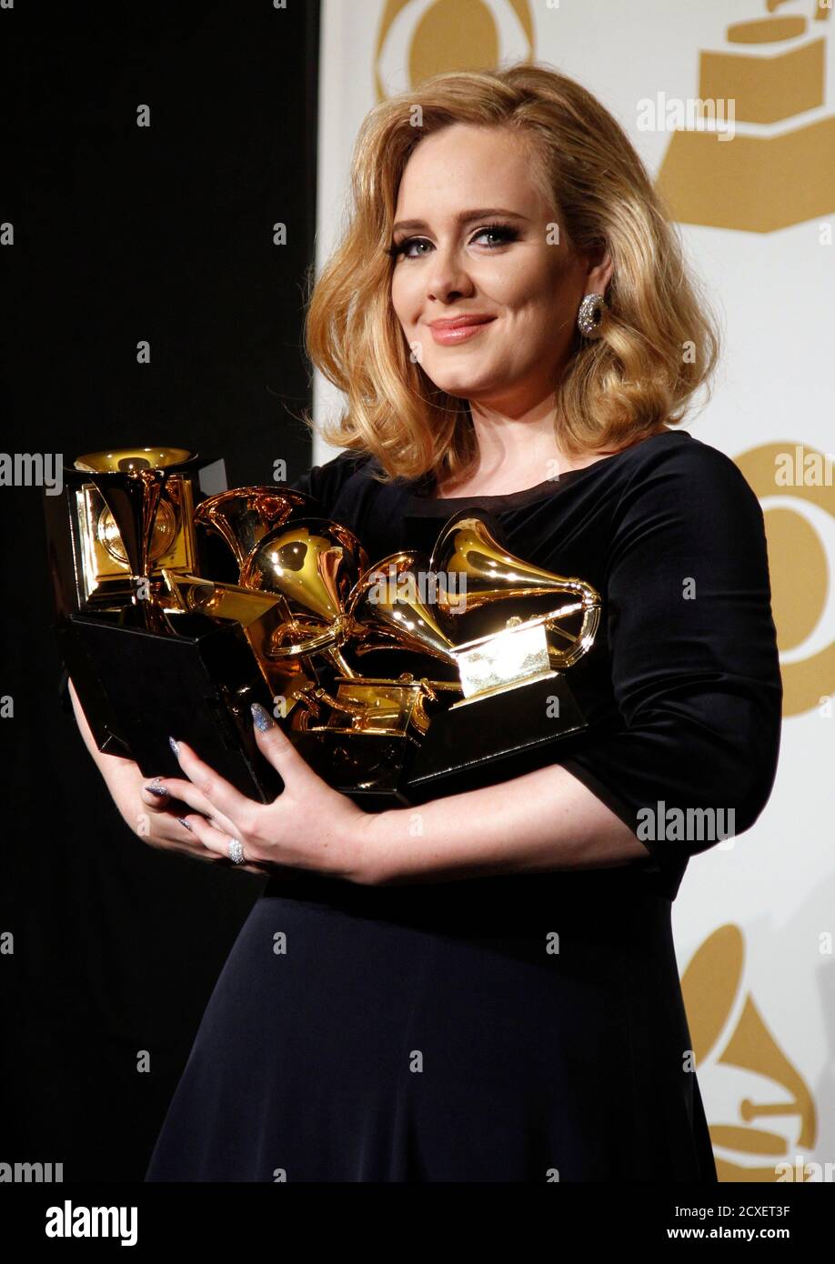 Singer Adele holds her six Grammy Awards at the 54th annual Grammy Awards  in Los Angeles, California February 12, 2012. Soul singer Adele triumphed  in her return to music's stage on Sunday,