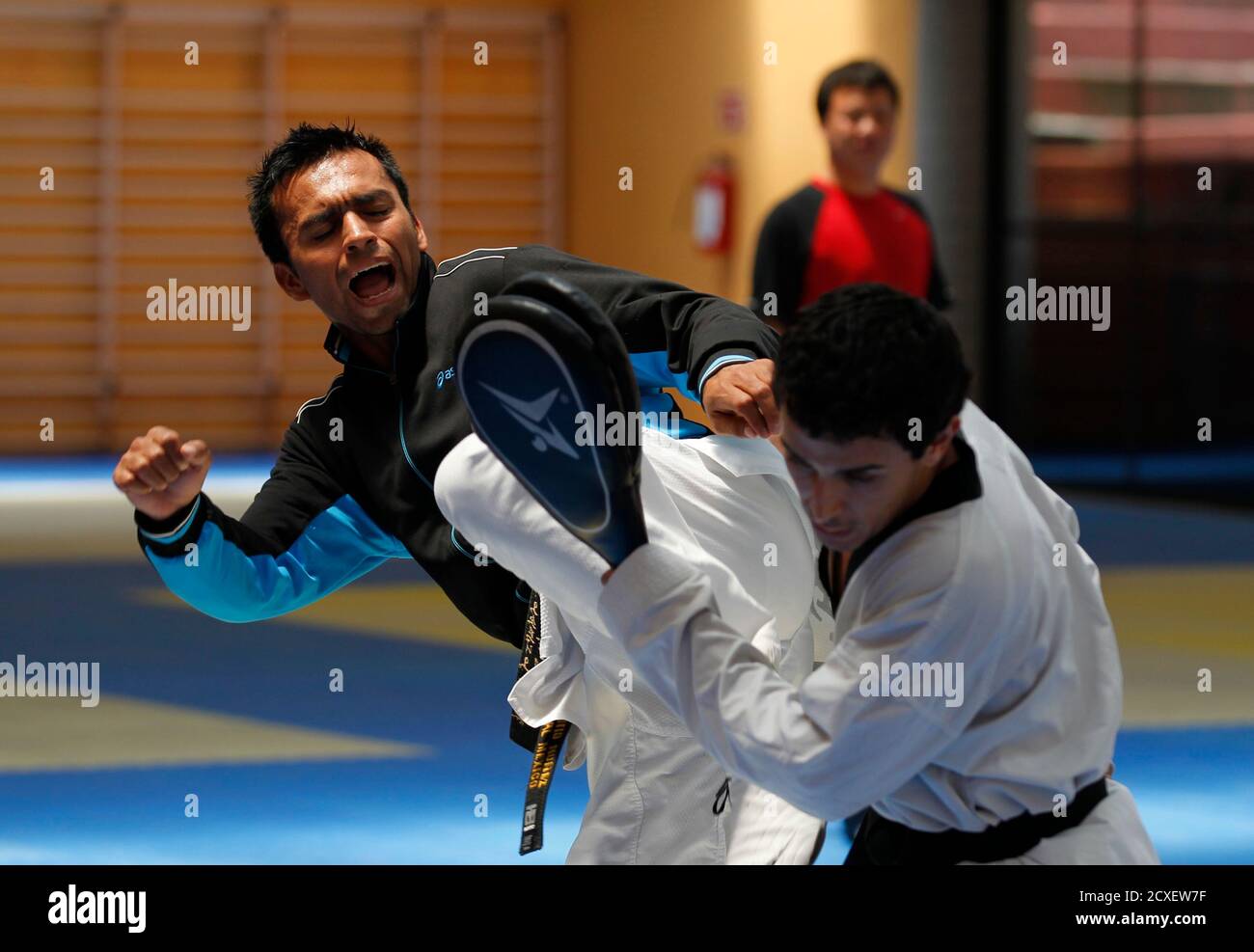 Mexican Taekwondo Fighter And Olympic Hopeful Erick Osornio Practices His Kicks With A Sparring Partner During A Training Session At The Mexican Olympic Committee Facilities Com In Mexico City April 20 2012