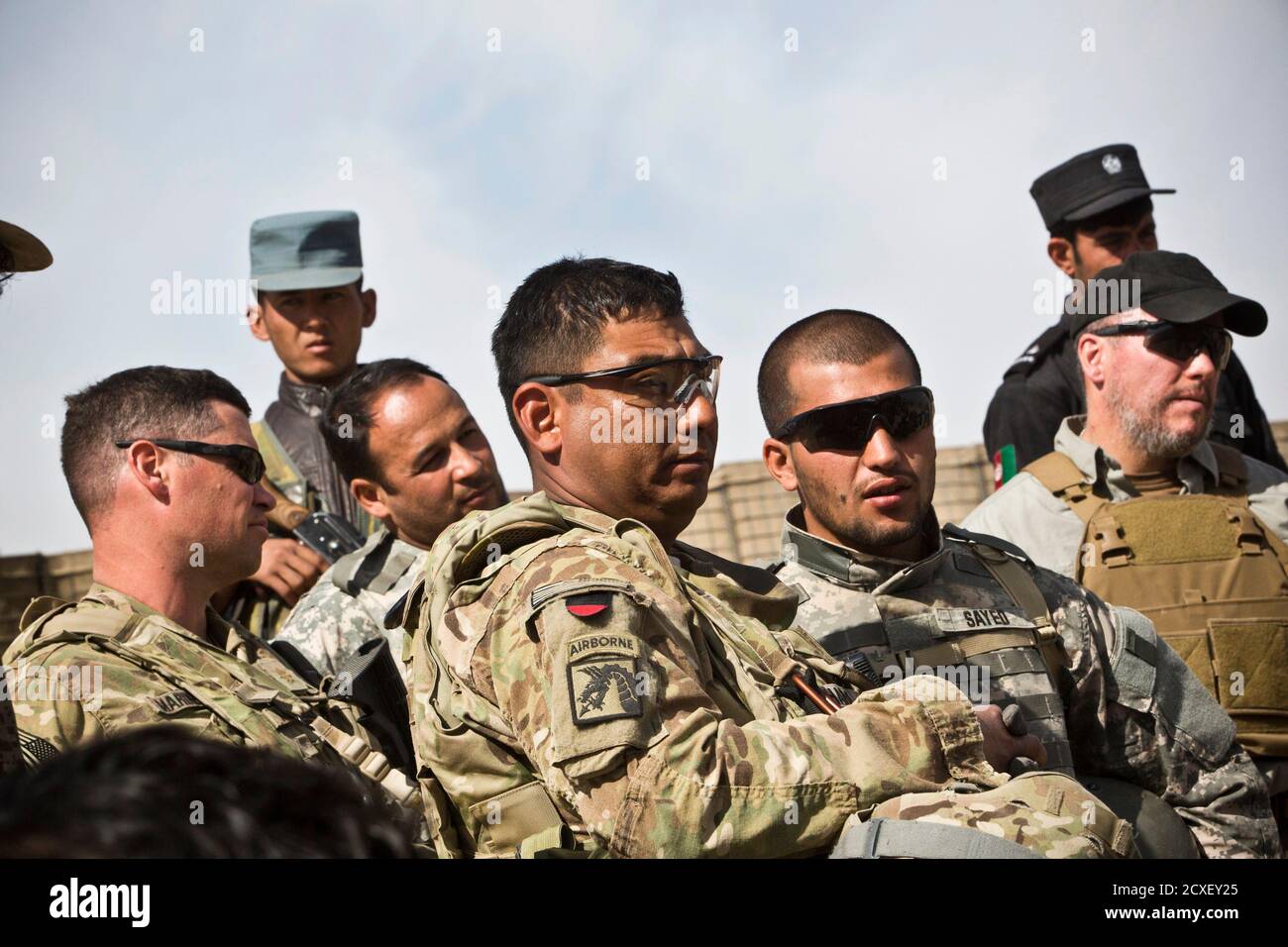 U.S. troops and members of the Afghan National Security Forces (ANSF) listen to a speaker at a shura - a meeting between village elders, U.S. troops and ANSF - near Command Outpost AJK (short for Azim-Jan-Kariz, a near-by village) in Maiwand District, Kandahar Province, Afghanistan, January 26, 2013. REUTERS/Andrew Burton (AFGHANISTAN - Tags: POLITICS) Stock Photo