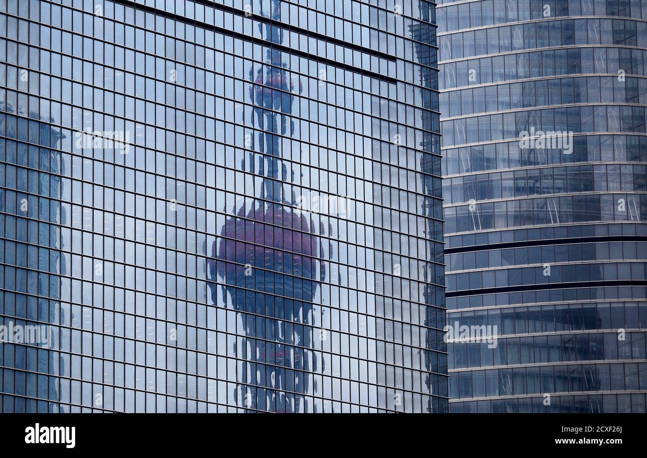 The Oriental Pearl TV Tower reflected on the facade of another building at  Pudong financial district in Shanghai April 2, 2014. China's Vice Premier  Zhang Gaoli called for faster construction of certain