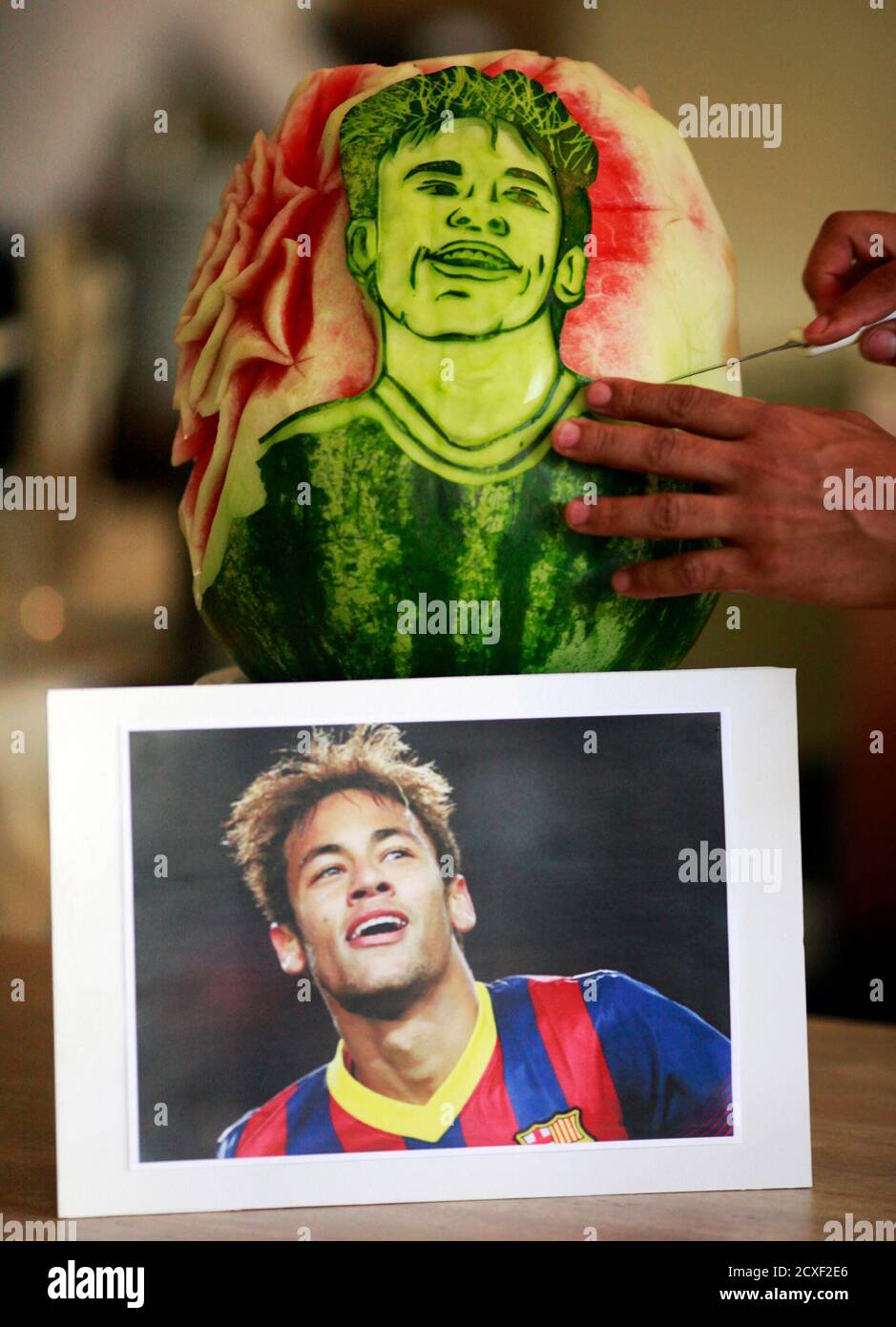 Chef Rogerio Holanda makes a carving of Brazil's soccer player Neymar in a watermelon at San Raphael hotel in Sao Paulo May 7, 2014. The 2014 World Cup will be held in Brazil from June 12 to July 13. REUTERS/Paulo Whitaker (BRAZIL - Tags: SPORT SOCCER WORLD CUP FOOD SOCIETY) Stock Photo