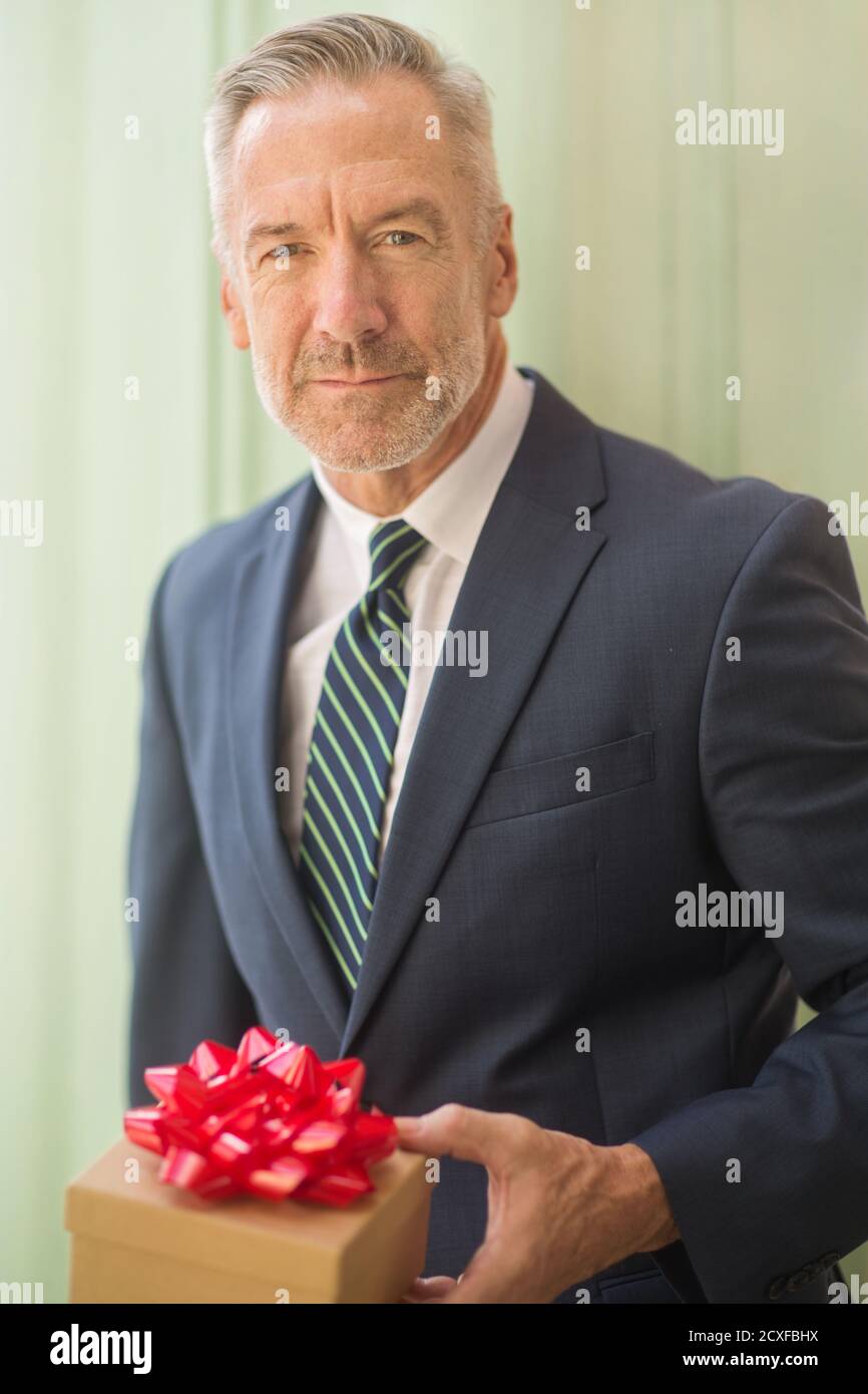 Mature handsome man giving a gift stock photo Stock Photo - Alamy