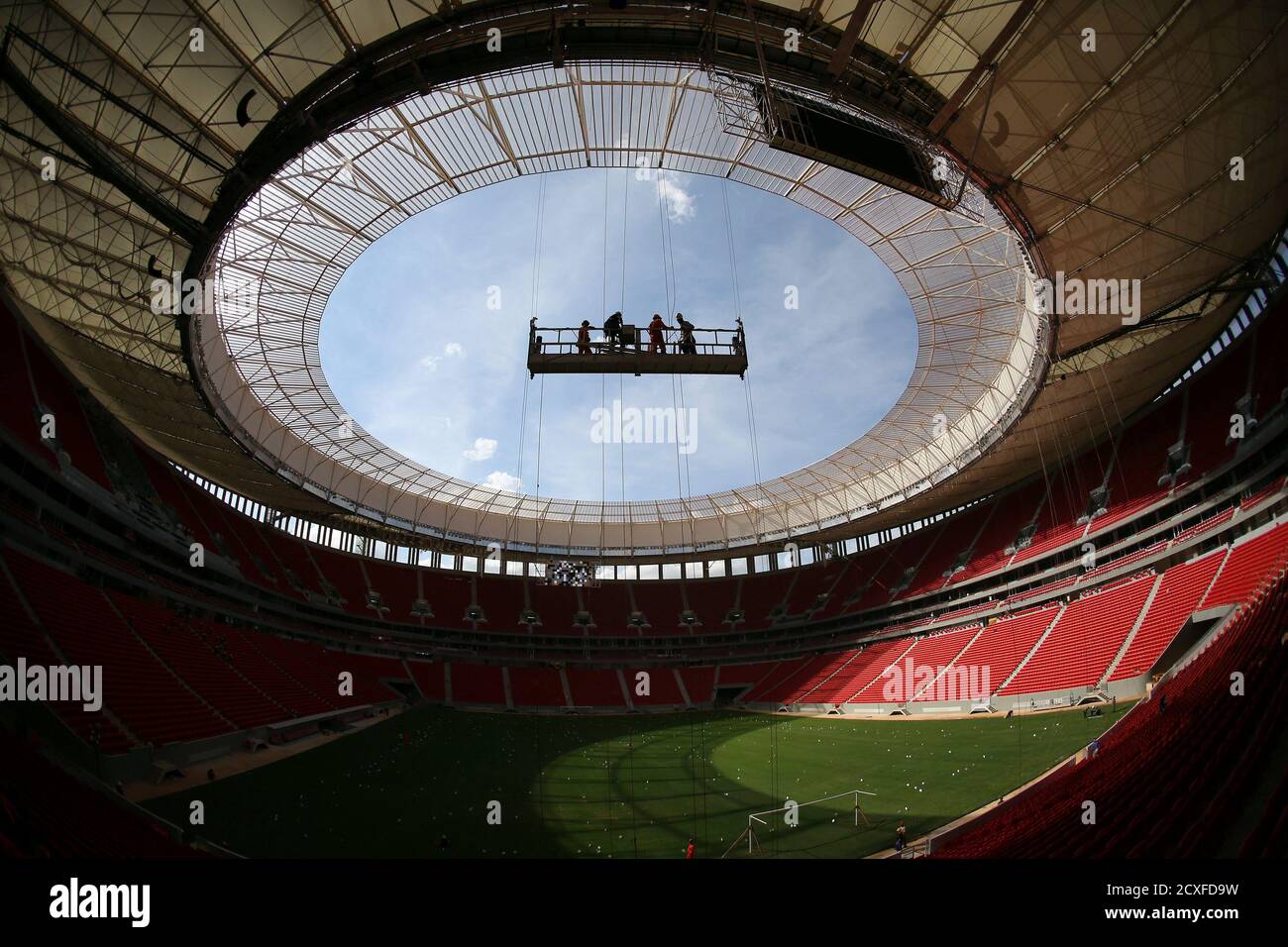 Labourers stand in a suspended platform at the National Mane Garrincha stadium in Brasilia May 10, 2013. The stadium will be one of the venues for the 2013 Confederations Cup and the 2014 World Cup. According to the consortium in charge, the construction of the stadium is considered around 97 percent complete. REUTERS/Ueslei Marcelino (BRAZIL - Tags: SPORT SOCCER BUSINESS CONSTRUCTION)  FOR BEST QUALITY IMAGE ALSO SEE: GM1E97B1LUM01 Stock Photo
