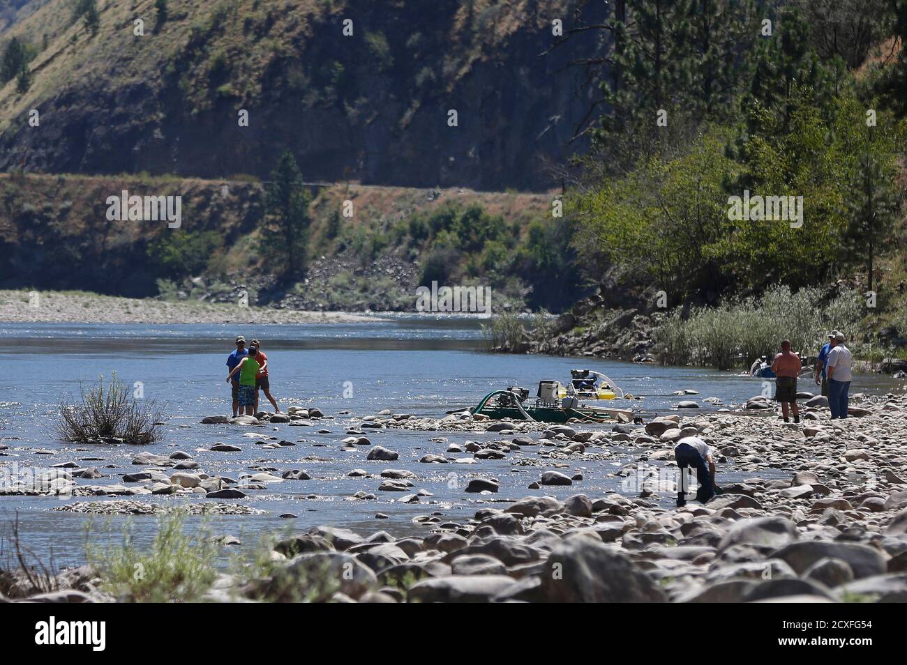Miners mine for gold along the Salmon River near Riggins, Idaho July 3, 2014. Citing states' rights, miners were using portable pumps and hoses to collect gravel and sand from the streambed of a stretch of the federally protected Salmon River, which is closed to suction dredging and other mining by the U.S. Environmental Protection Agency to protect imperiled fish.  REUTERS/Jim Urquhart  (UNITED STATES - Tags: POLITICS ENVIRONMENT BUSINESS COMMODITIES CIVIL UNREST) Stock Photo