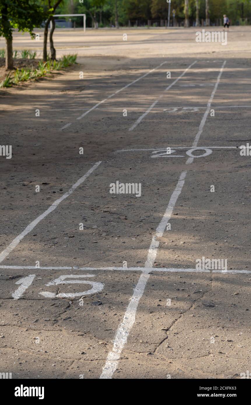 White lines and numbers on the asphalt of the school playground. Scale