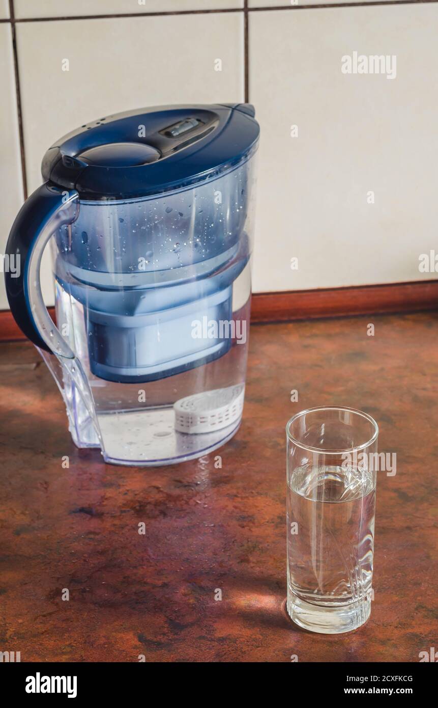 Water filter jug ​​with shungite cartridge inside on the kitchen counter.  Shungite cartridge for cleansing and saturation of liquid with minerals.  Pla Stock Photo - Alamy