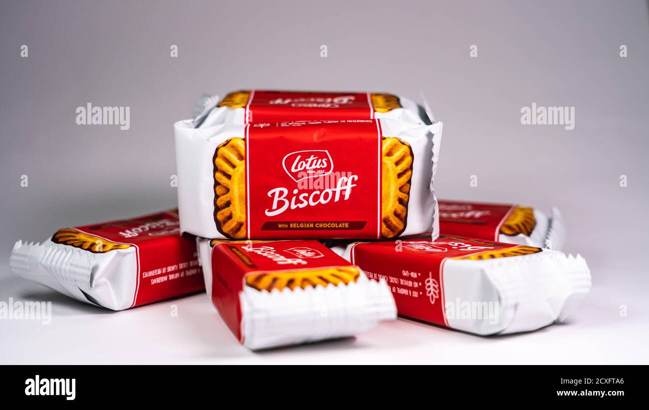 A few packets of Lotus Biscoff Belgian chocolate cookies on a white background Stock Photo