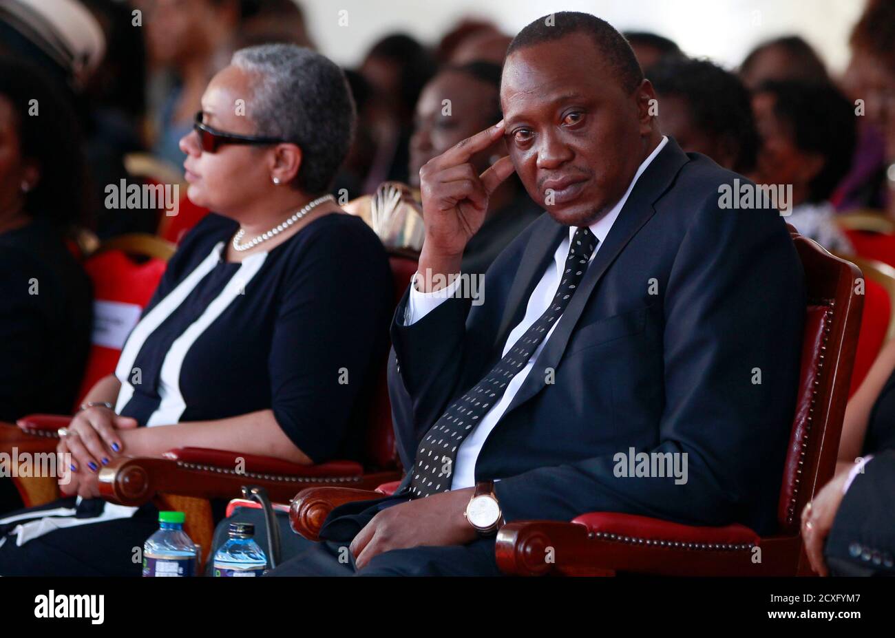 Kenyan President Uhuru Kenyatta attends the burial of his nephew Mbugua Maina and Maina's fiancee Rosemary Wahito, who were both killed during the Westgate Mall shopping mall attack, in Gatundu village near Nairobi, September 27, 2013. At least 72 people were killed in the attack which occurred over the weekend. REUTERS/Thomas Mukoya (KENYA - Tags: CIVIL UNREST CRIME LAW OBITUARY) Stock Photo