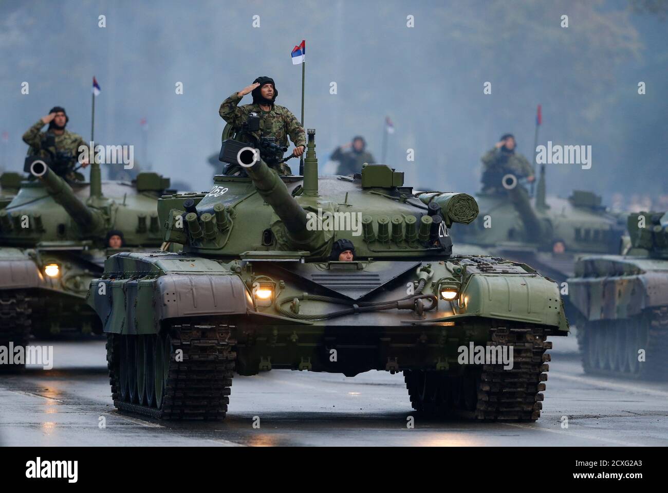 Serbian troops salute from the top of their tanks during a military parade  to mark 70 years since the city's liberation by the Red Army in Belgrade  October 16, 2014. Russian President