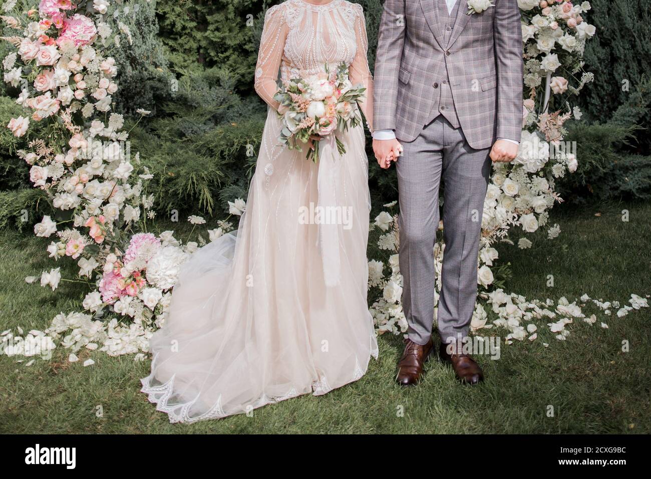 a groom with bride near the wedding arch Stock Photo - Alamy