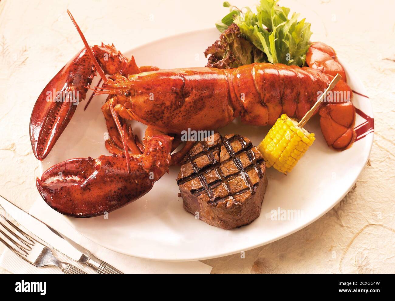 Grilled lobster and beef steak on dinner plate Stock Photo Alamy