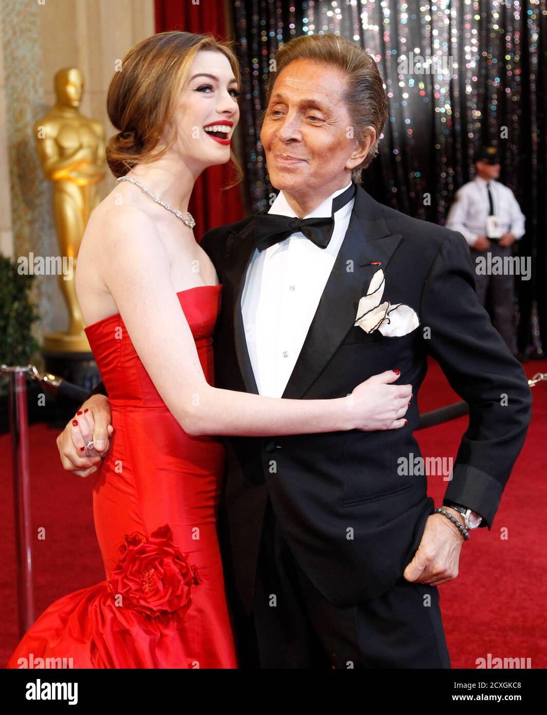 Actress and co-host Anne Hathaway poses with designer Valentino (R) at the  83rd Academy Awards in Hollywood, California, February 27, 2011. REUTERS/ Mario Anzuoni (UNITED STATES - Tags: ENTERTAINMENT FASHION)  (OSCARS-ARRIVALS Stock Photo -