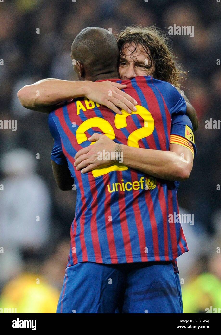 Barcelona's Eric Abidal (front) and Carles Puyol embrace during their  Spanish King's Cup quarter-final first leg 