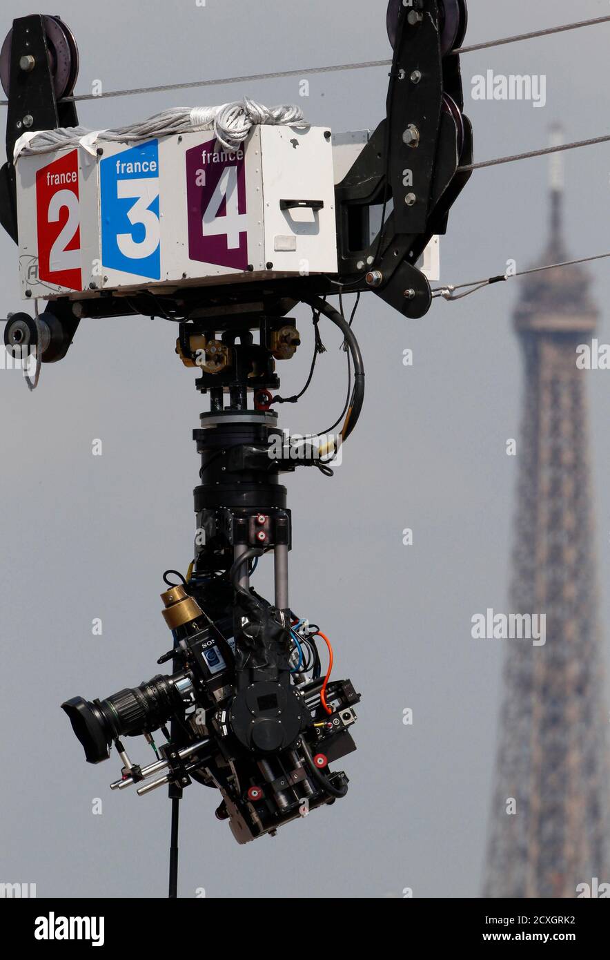 A France Television TV broadcast camera is pictured during the French Open  tennis tournament at the Roland Garros stadium in Paris May 29, 2012. In  the background, the Eiffel Tower. REUTERS/Regis Duvignau (