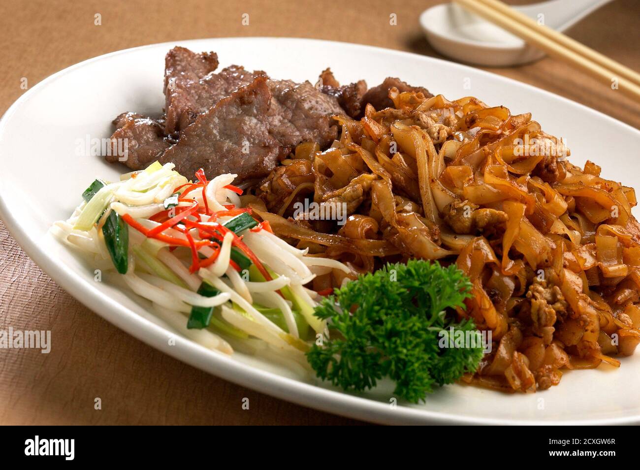 Asian cuisine stir fry noodles with beef and bean sprout Stock Photo