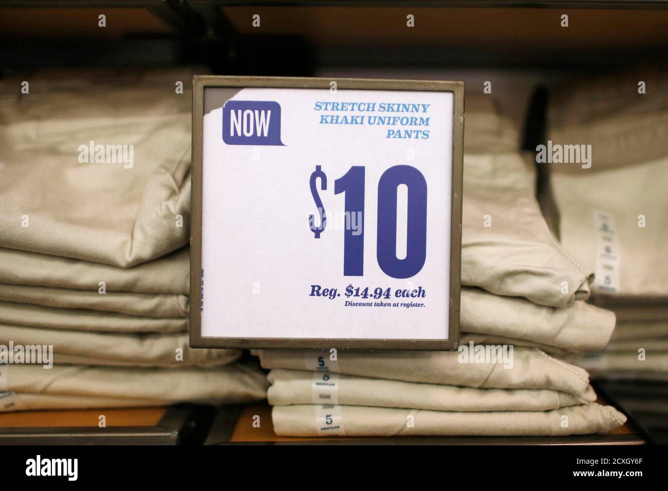 Khaki uniform pants are stacked at an Old Navy clothing store ...