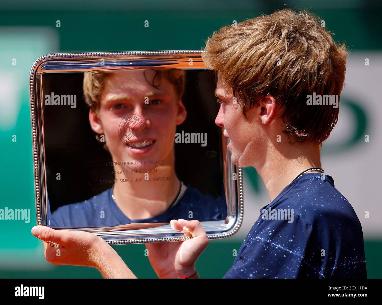 Andrey Rublev of Russia poses with the trophy after winning the junior boys  final against Jaume Antoni Munar Clar of Spain during the French Open  tennis tournament at the Roland Garros stadium