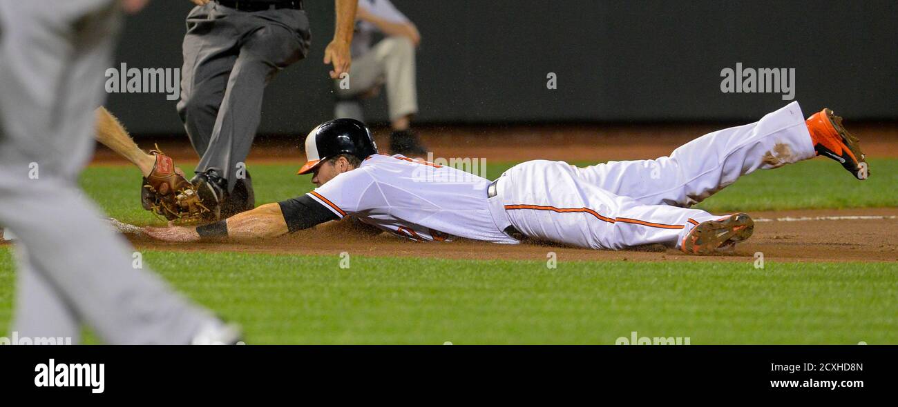Baltimore Orioles Baserunner Chris Davis Dives Safely Into Third Base After A Wild Pitch By New York Yankees Relief Pitcher Shawn Kelley During The Eighth Inning Of Their Mlb American League Baseball Baltimore Orioles Baserunner Chris Davis Dives Safely Into Third Base After A Wild Pitch By New York Yankees Relief Pitcher Shawn Kelley During The Eighth Inning Of Their Mlb American League Baseball