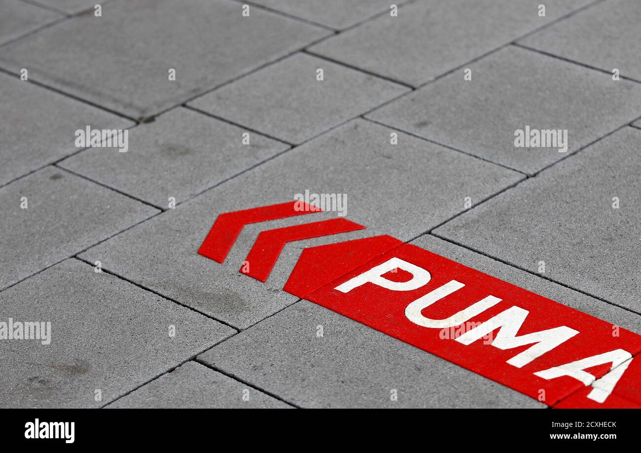 German sports goods firm Puma's sign is seen on the street before the  company's annual news conference in Herzogenaurach February 20, 2014. Puma  hopes a raft of high-profile signings will stop sales