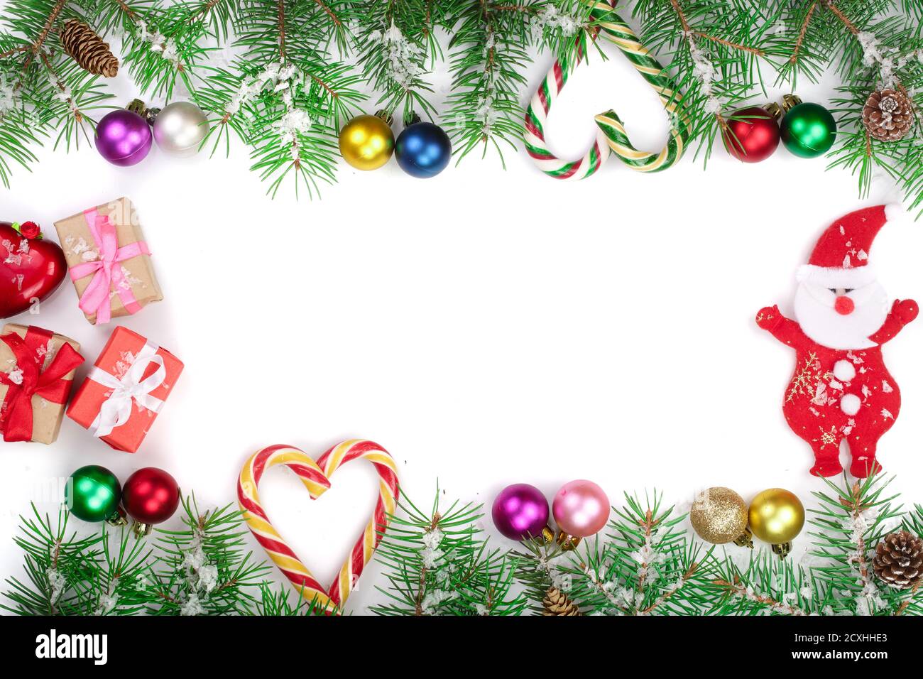 Christmas Frame of Fir tree branch with candy canes and balls isolated ...