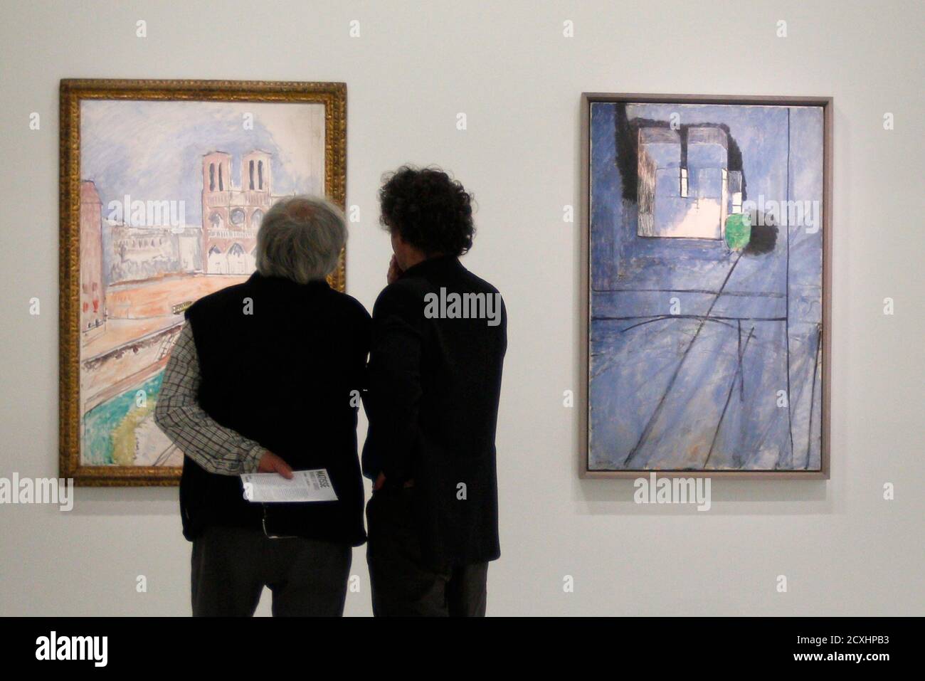 Visitors look at the paintings "Notre Dame" at L, and "Vue de Notre-Dame" ( View of Notre Dame, 1914) by French painter Henri Matisse (1859-1954)  during the press presentation of the exhibition "Matisse,