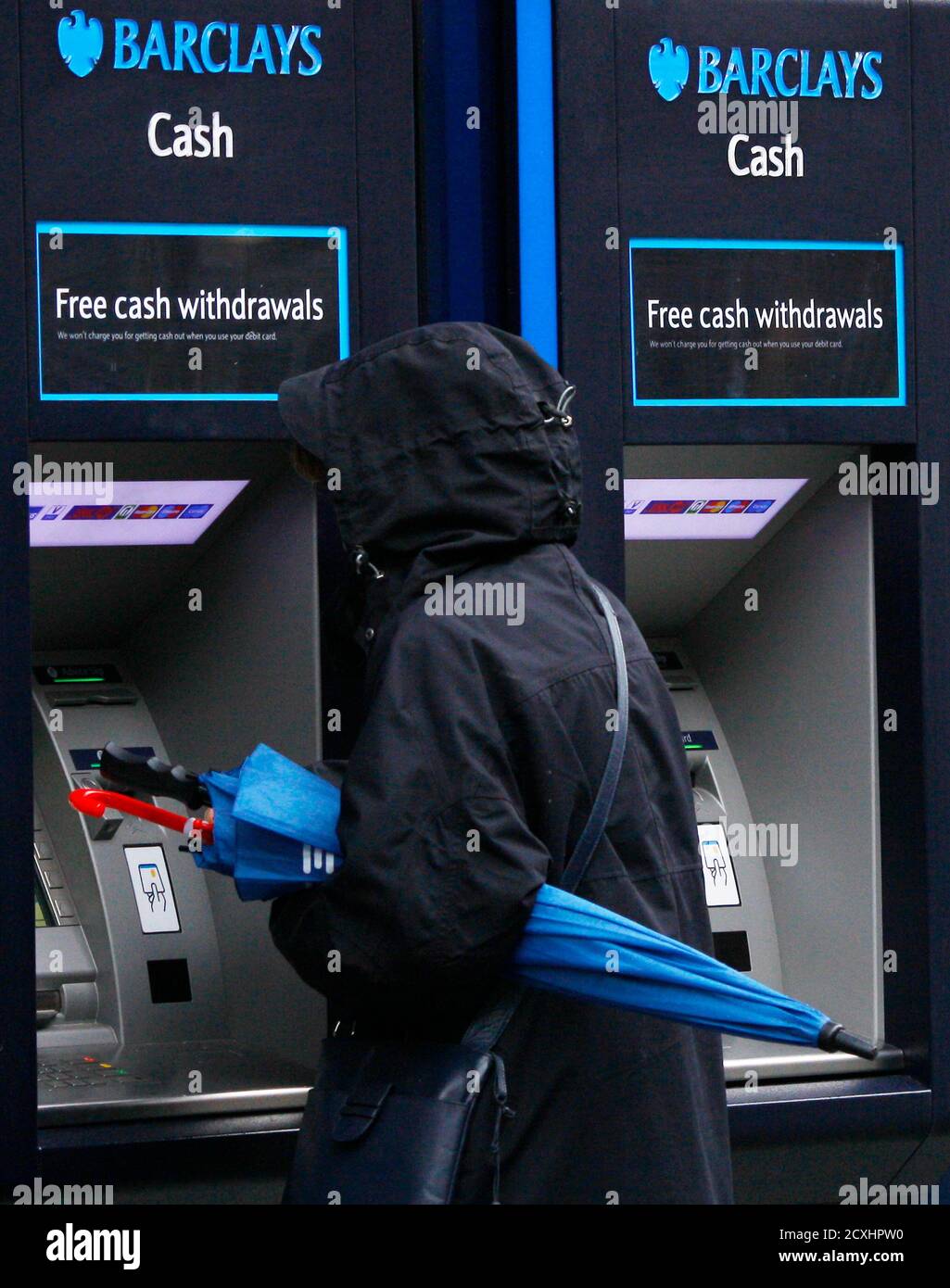 A woman uses a cash machine at a Barclays bank in Altrincham, northern England April 26, 2012. Barclays posted a 22 percent rise in first-quarter profit, ahead of market forecasts, as a strong rebound in revenue from its investment banking arm and a drop in bad debt countered increased compensation for insurance mis-selling.  REUTERS/Phil Noble (BRITAIN - Tags: BUSINESS EMPLOYMENT) Stock Photo