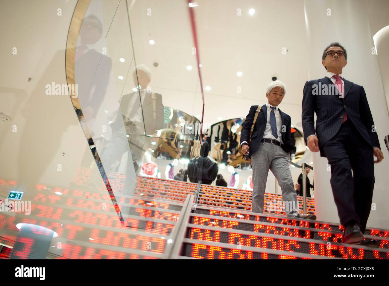 People walk down the stairways of the Uniqlo Global flagship store during a  preopening in Berlin, April 10, 2014. Japanese casual wear chain Uniqlo  opens its first store in Germany on Friday,