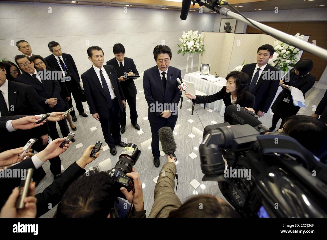 Japan's Prime Minister Shinzo Abe speaks to the media after signing a condolences book for the late Lee Kuan Yew, former Prime Minister of Singapore, at the Singapore Embassy in Tokyo March 24, 2015. Lee, Singapore's first prime minister and architect of the tiny Southeast Asian city-state's rapid rise from British tropical outpost to global trade and financial centre, died early on Monday, aged 91, the Prime Minister's Office said. REUTERS/Eugene Hoshiko/Pool Stock Photo