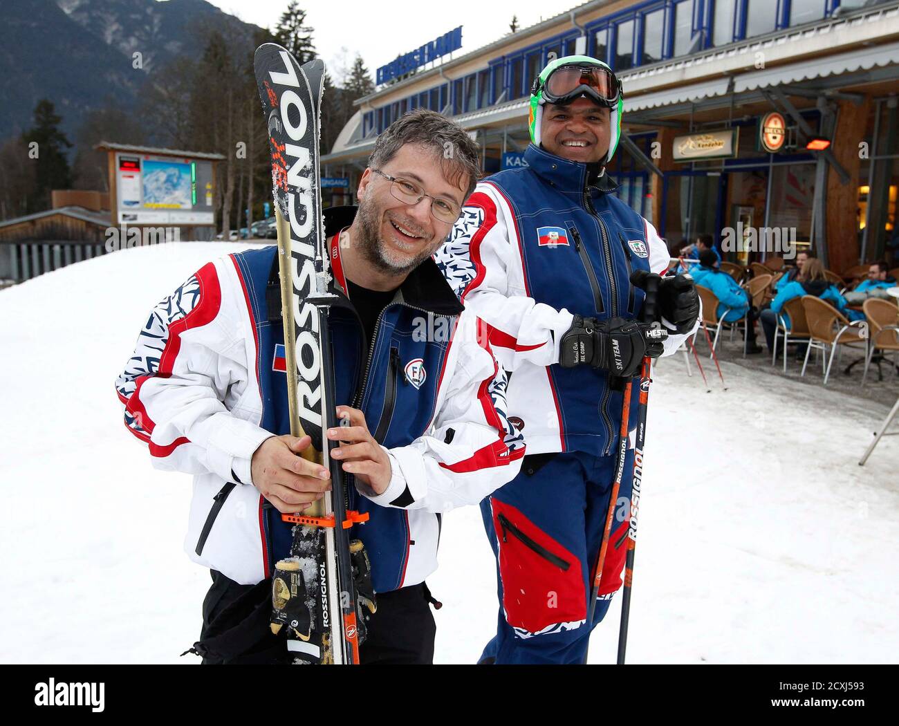 Haitian skier Jean-Pierre Roy (R) and his French coach Thierry Montillet  pack up their skis after a training at the World Alpine skiing  Championships in Garmisch Partenkirchen February 11, 2011. Roy, 47,
