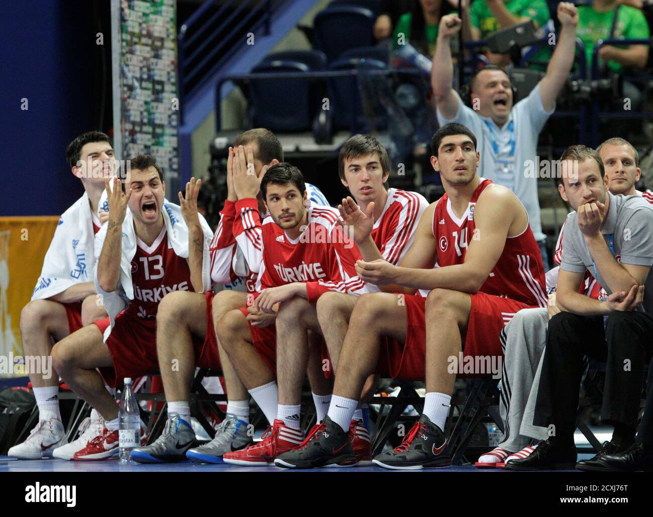 Turkey's Ender Arslan (2nd L) reacts as he sits on the bench with his teammates during their FIBA EuroBasket 2011 Group E basketball game against Germany in Vilnius September 9, 2011.  REUTERS/Ints Kalnins (LITHUANIA - Tags: SPORT BASKETBALL) Stock Photo