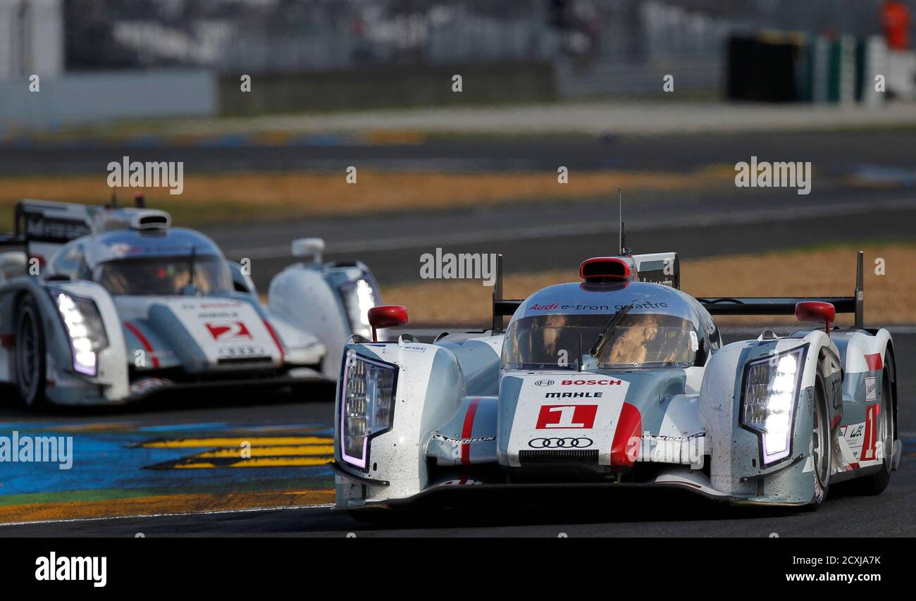 Benoit Treluyer of France drives his Audi R18 E-Tron Quattro Number 1 ahead  the Number 2 driven by Denmark's Tom Kristensen during Le Mans 24-hour  sportscar race in Le Mans, central France