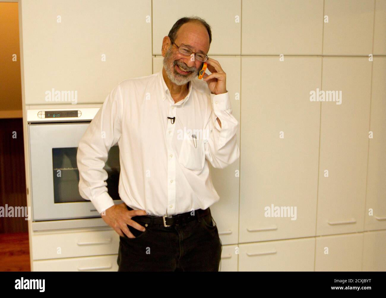 2012 Economics Nobel Prize winner Alvin Roth receives congratulatory phone  calls at his home in Menlo Park, California, on Monday, October 15, 2012.  U.S. economist Alvin Roth, winner of the 2012 Nobel