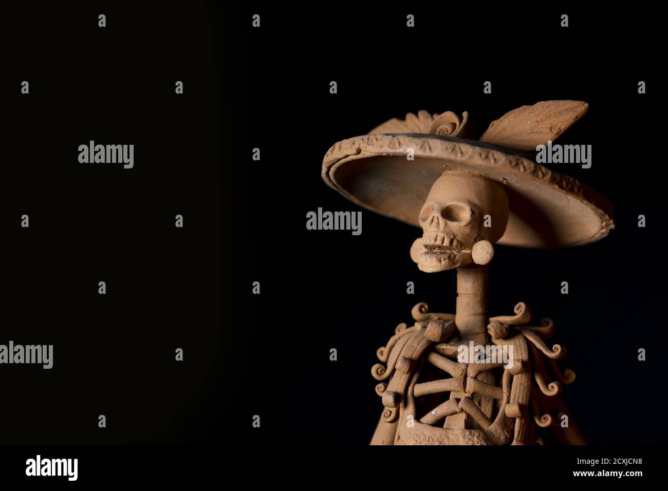 Closeup shot of a skeleton figurine prepared for the day of the dead on a dark background Stock Photo