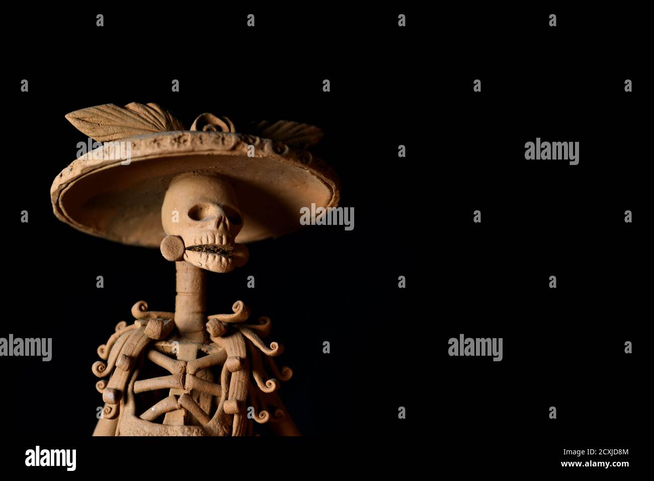 Closeup shot of a skeleton figurine prepared for the day of the dead on a dark background Stock Photo