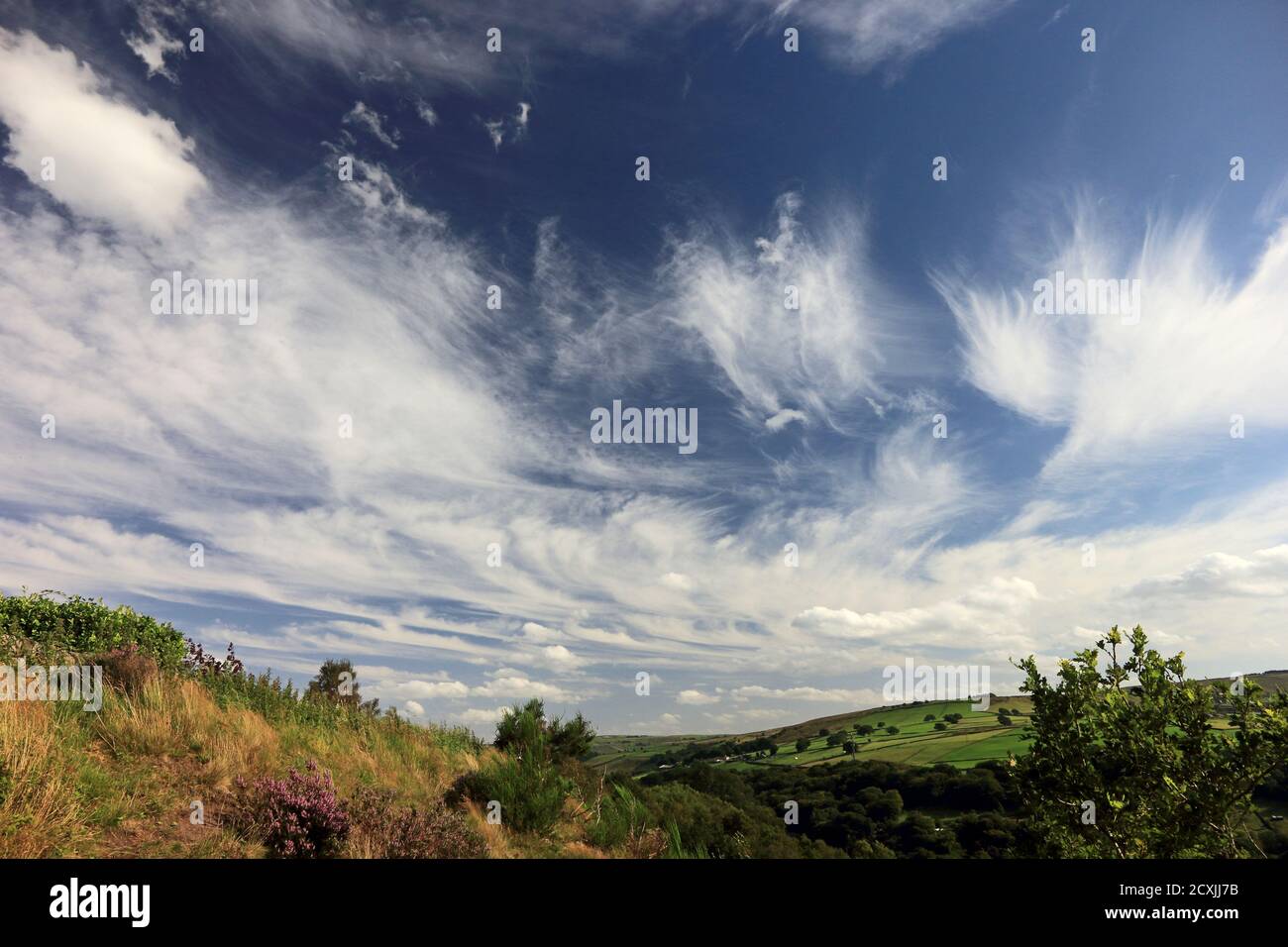 Clouds in blue sky over pennine hills Stock Photo