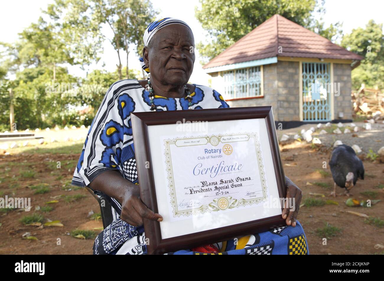 Sarah Hussein Obama, grandmother to U.S. President Barack Obama holds a certificate she received from the Rotary cluf of Nairobi at their homestead in his ancestral village of Nyang'oma Kogelo, west of Kenya's capital Nairobi, July 14, 2015. Obama visits Kenya and Ethiopia in July, his third major trip to Sub-Saharan Africa after travelling to Ghana in 2009 and to Tanzania, Senegal and South Africa in 2011. He has also visited Egypt, in North Africa, and South Africa for Nelson Mandela's funeral. Obama will be welcomed by a continent that had expected closer attention from a man they claim as  Stock Photo