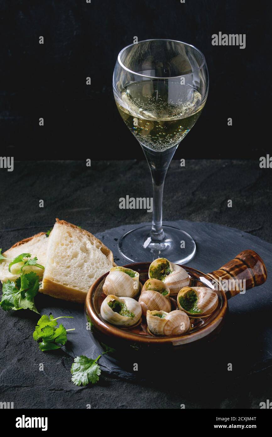 Escargots De Bourgogne Snails With Herbs Butter Gourmet Dish In Traditional Ceramic Pan With Parsley Bread And Glass Of White Wine On Stone Slate Stock Photo Alamy Escargots De Bourgogne Snails With Herbs Butter Gourmet Dish In Traditional Ceramic Pan With Parsley Bread And Glass Of White Wine On Stone Slate Stock Photo Alamy