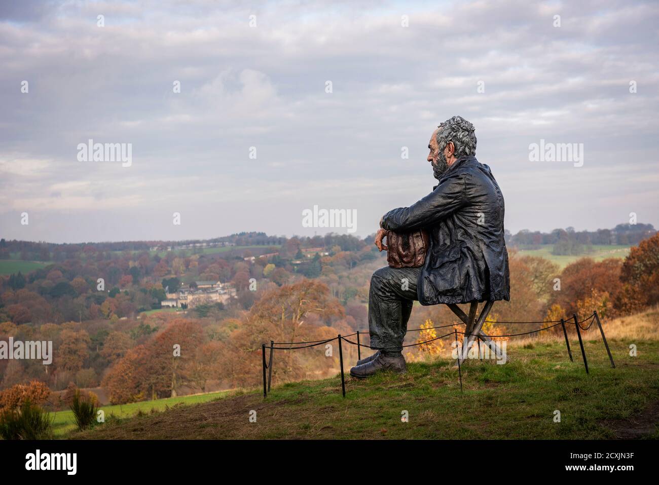 The artist Sean Henry's sculpture 'Seated Figure' at the Yorkshire Sculpture Park near Wakefield, Yorkshire, UK Stock Photo