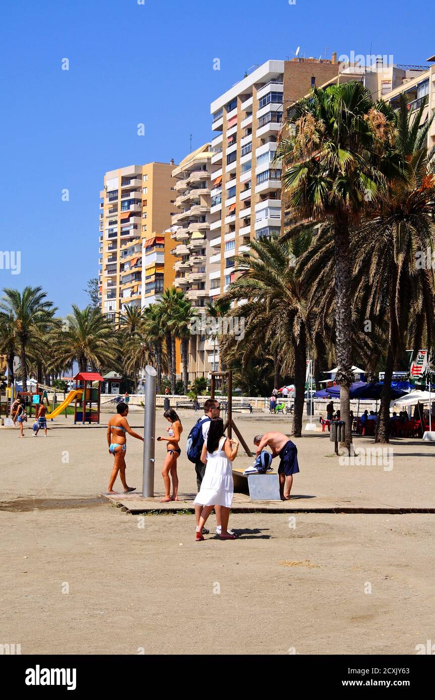 Holidaymakers using the shower on Malagueta beach, Malaga; Spain. Stock Photo