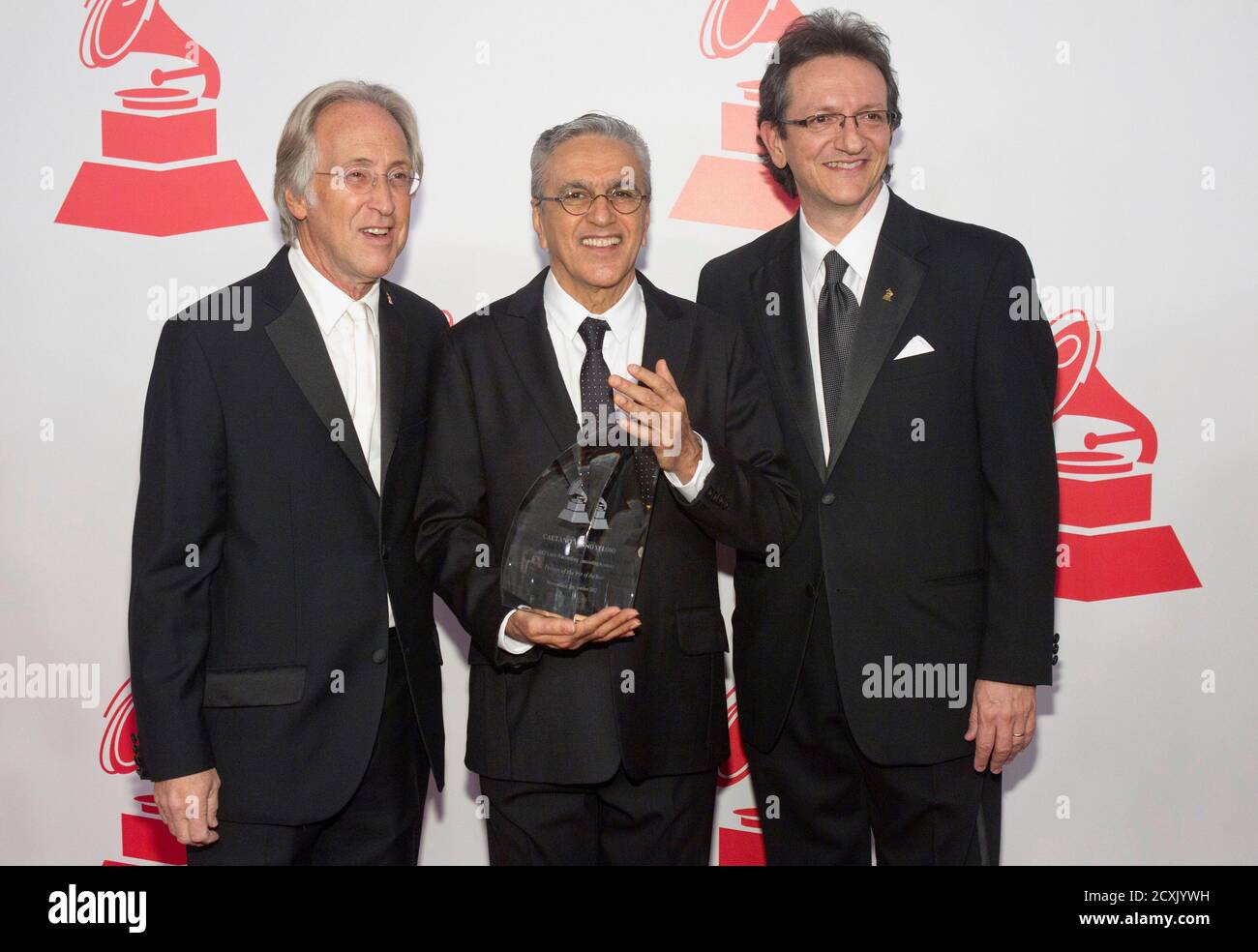 Neil Portnow (L), president of the National Academy of Recording Arts and Sciences, honoree Caetano Veloso (C) and Gabriel Abaroa Jr., president and CEO of the Latin Academy of Recording Arts and Sciences, arrive for the 2012 Latin Recording Academy Person of the Year tribute dinner and concert at the MGM Grand Garden Arena in Las Vegas, Nevada November 14 , 2012. REUTERS/Steve Marcus (UNITED STATES - Tags: ENTERTAINMENT) Stock Photo