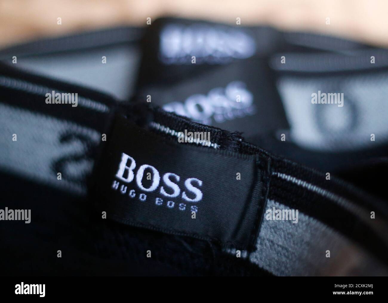 The logo of German fashion house Hugo Boss is seen on a clothing label at  their outlet store in Mezingen near Stuttgart October 29, 2013. German  fashion house Hugo Boss said it
