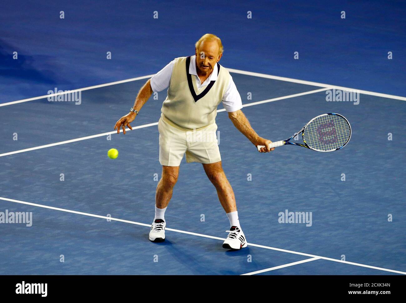 Australian tennis legend Rod Laver plays a shot against Switzerland's Roger  Federer at Rod Laver Arena during a charity event in Melbourne January 8,  2014. REUTERS/David Gray (AUSTRALIA - Tags: SPORT TENNIS
