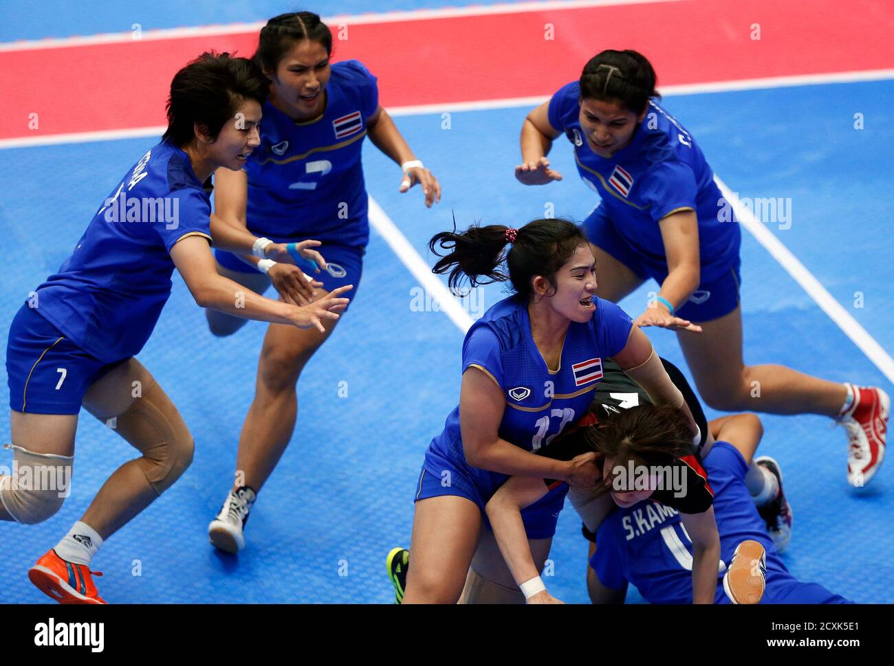 Thailand's players tackles Japan's Yumi Kaneko during their women's preliminary kabaddi match in the Songdo Global University Gymnasium at the 17th Asian Games in Incheon September 29, 2014.  REUTERS/Olivia Harris (SOUTH KOREA - Tags: SPORT) Stock Photo