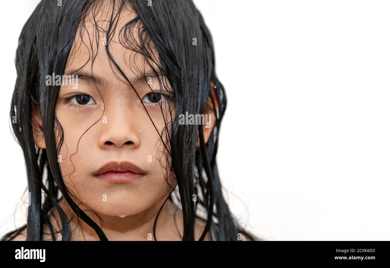 Close up face of Asian child girl on white background, wet face and hair,  water drops on face and hair, unpredictable or cold emotion, eyes looking  at Stock Photo - Alamy