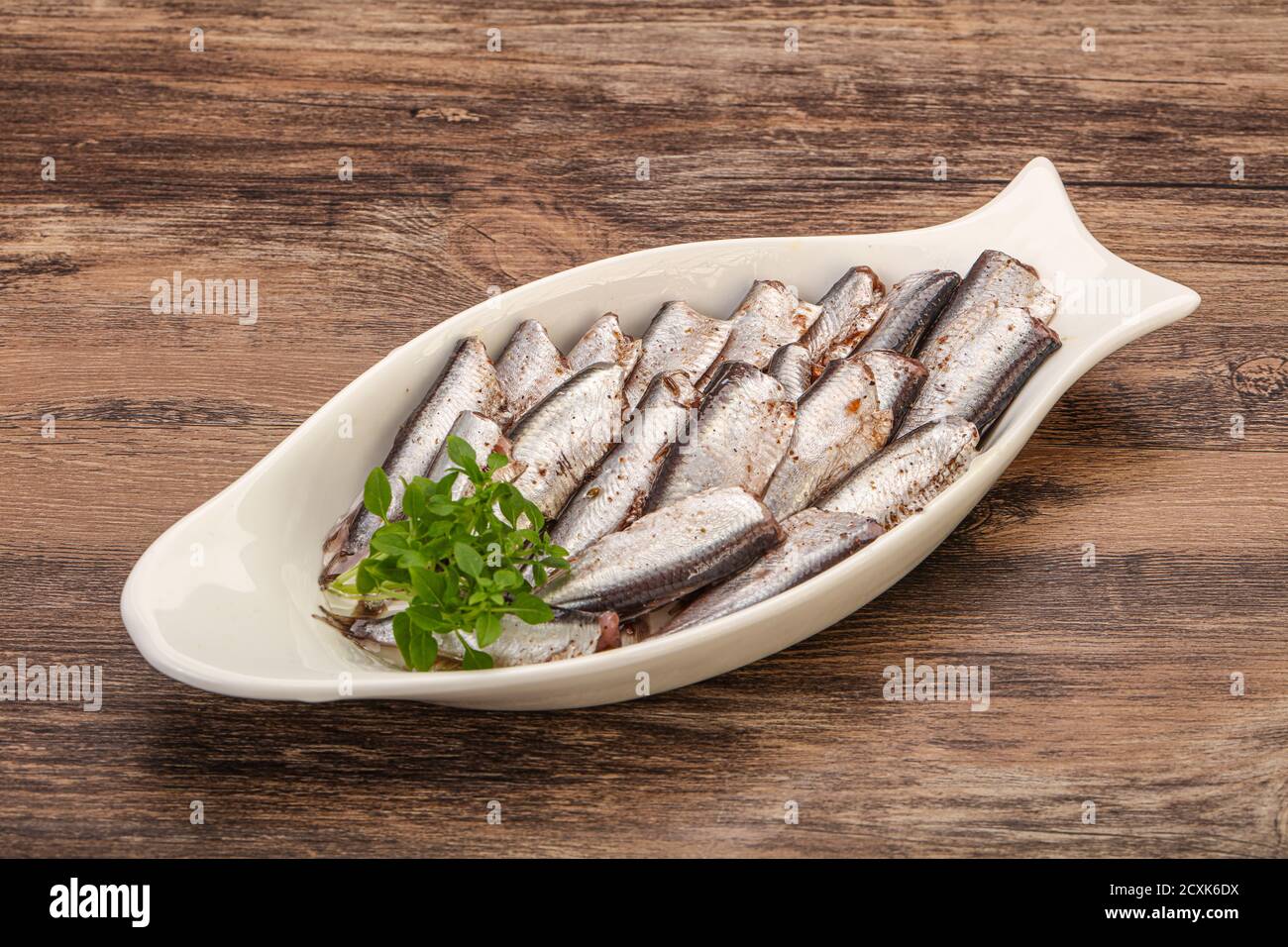 Anchovies fish snack in the bowl served basil leaves Stock Photo Alamy