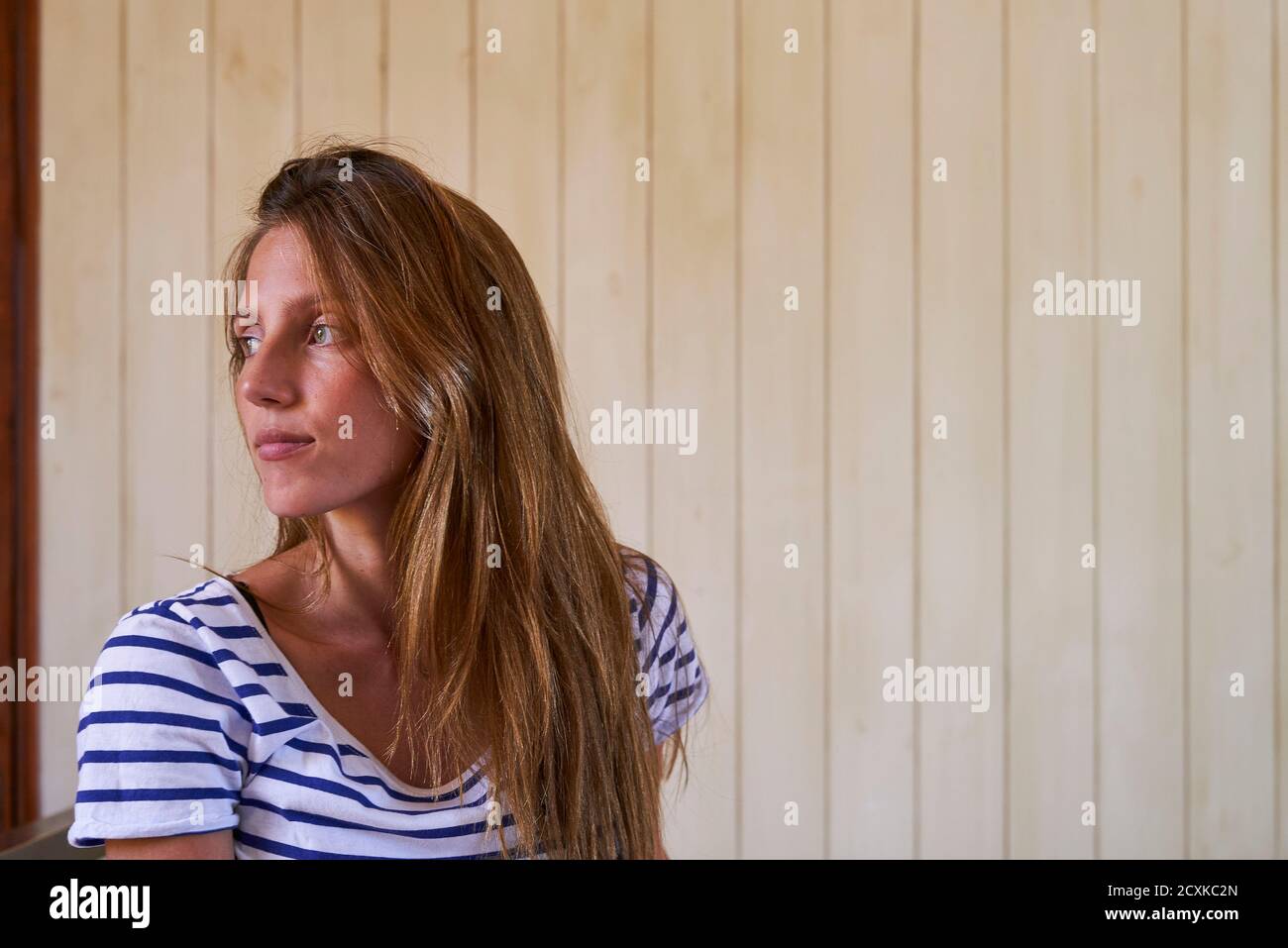 Beautiful young woman sitting on bed Stock Photo - Alamy